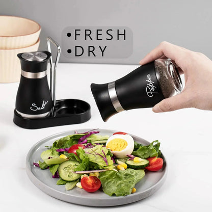 Stainless Steel Salt and Pepper Shakers Set with Holder - 2-Piece Black Compact Kitchenware, Refillable Seasoning Containers with Clear Glass Bottoms and Screw-Off Perforated Caps